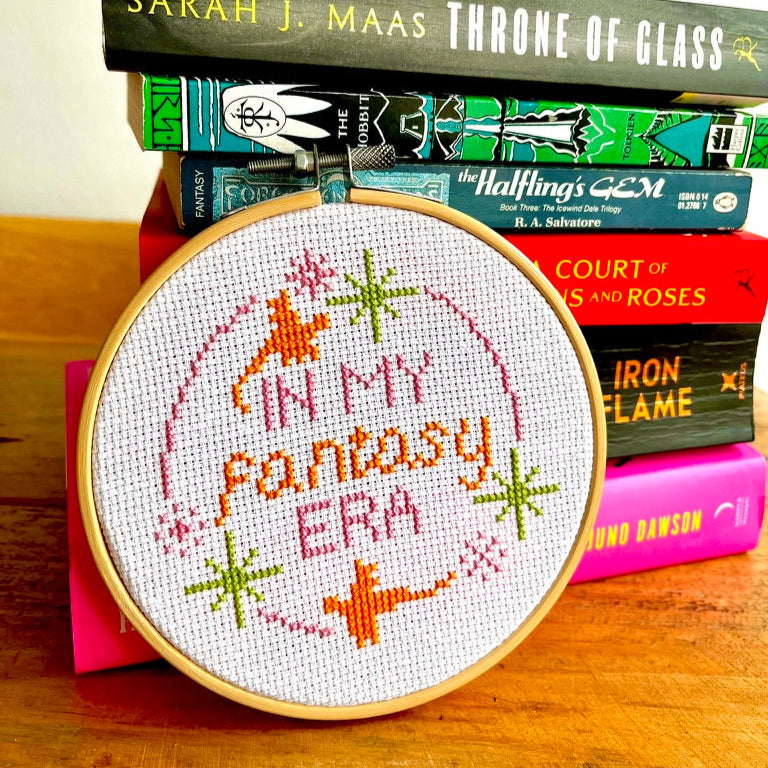 Embroidery hoop with 'In My Fantasy Era' design pictured with fantasy books